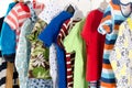 Dressing closet with clothes arranged on hangers.