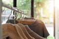 Colorful warm sweaters with different patterns on hanger open clothes rail Royalty Free Stock Photo