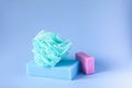Colorful washcloths and bar of soap on a blue background. Accessories for body care and hygiene