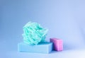 Colorful washcloths and bar of soap on a blue background. Accessories for body care and hygiene