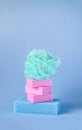 Colorful washcloths and bars of soap on a blue background. Accessories for body care and hygiene