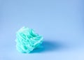 Colorful washcloths and bars of soap on a blue background. Accessories for body care and hygiene