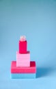 Colorful washcloths, small plastic travel bottle and bars of soap on a blue background. Accessories for body care and hygiene