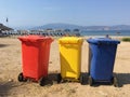 Colorful waste collection containers in a beach near the city of Nafplio