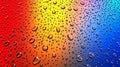 Colorful water droplets on rainbow gradient background Royalty Free Stock Photo