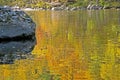 Colorful water reflection on the Pigeon River in fall. Royalty Free Stock Photo