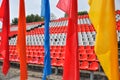 Colorful waving flags and empty seats in the stands of the arena