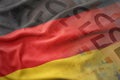 Colorful waving national flag of germany on a euro money banknotes background. Royalty Free Stock Photo