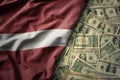 colorful waving national flag of latvia on a american dollar money background. finance concept Royalty Free Stock Photo