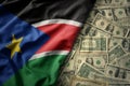 colorful waving national flag of south sudan on a american dollar money background. finance concept Royalty Free Stock Photo