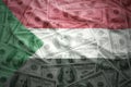 Colorful waving sudanese flag on a dollar money background Royalty Free Stock Photo