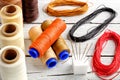 Colorful wax cord, leather thread on white wooden background for leather crafting, wicker work and handcrafts.
