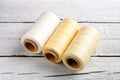 Colorful wax cord, leather thread on white wooden background for leather crafting, wicker work and handcrafts.