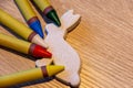 Colorful wax crayons on a table with a rabbit Royalty Free Stock Photo