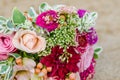 Colorful wedding bouquet from roses. Pink, red and green. Beach wedding. Royalty Free Stock Photo