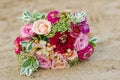 Colorful wedding bouquet from roses. Pink, red and green. Beach wedding. Royalty Free Stock Photo