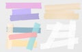 Colorful and white adhesive, sticky, masking, duct tape, paper strips, pieces for text on gray background Royalty Free Stock Photo