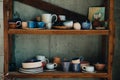 Colorful, white and blue ceramic cups and dishes on shelves of pottery store Royalty Free Stock Photo