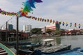 Colorful wind chime flags at a harbor