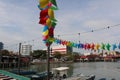 Colorful wind chime flags at a harbor