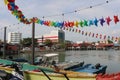 Colorful wind chime flags at a harbor