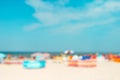 Colorful windbreaks on a sandy seaside beach - intentionally - in camera - blurred image