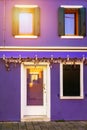 Colorful window of a house on the Venetian island of Burano, Venice. Facade of the houses of Burano close-up. Venice, Italy