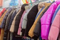 Colorful winter jackets hanging on a rack in a store Royalty Free Stock Photo