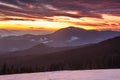 Colorful winter morning in the mountains. Dramatic overcast sky.