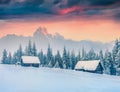 Colorful winter sunset in old farm in mountains Royalty Free Stock Photo