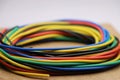 Colorful wire roll used in making electrical circuit connection between devices. Colorful electrical cables closeup Royalty Free Stock Photo