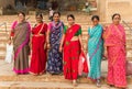 Colorful women posing on the stairs at the ghats in Varanasi