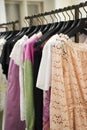 Colorful Women`s dresses on hangers in a fashion store. Shop stylish clothes, close-up. - image. Royalty Free Stock Photo