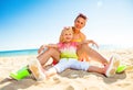 Happy modern mother and daughter sitting on seacoast Royalty Free Stock Photo