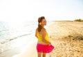 Happy modern woman on seashore in evening walking Royalty Free Stock Photo