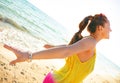 Happy modern woman on seacoast in evening rejoicing Royalty Free Stock Photo