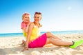 Happy trendy mother and daughter on seashore Royalty Free Stock Photo