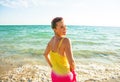 Smiling modern woman on seashore in evening having fun time Royalty Free Stock Photo