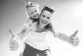 Smiling trendy mother and child on beach showing thumbs up Royalty Free Stock Photo