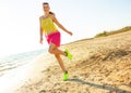 Smiling young woman on beach in evening having fun time Royalty Free Stock Photo