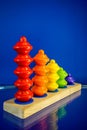 Colorful wood children toys for learning skills against dark blue wall