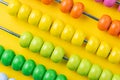 Colorful wooden abacus beads on vivid yellow background, business financial or accounting profit and loss concept, or use in educ Royalty Free Stock Photo