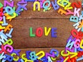 Colorful wooden alphabet love spelling on wooden background