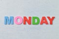 Colorful wooden alphabet with text MONDAY. A happy Monday concept