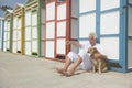 Colorful beach huts and senior man with dog Royalty Free Stock Photo