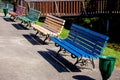 Colorful wooden benches with cast metal legs in the park