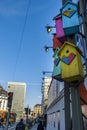 Colorful wooden bird breeding boxes or nests on a pole