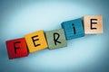 Colorful wooden blocks for children with the words `Ferie` in Polish, which means a winter break in school for schools in Poland