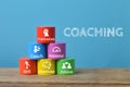Colorful wooden blocks with coaching symbols