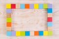 Colorful wooden blocks frame on white wooden background, top view with copy space Royalty Free Stock Photo